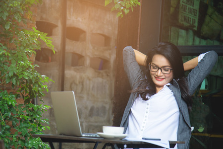 Sleepy businesswoman overworking, making mistake, taking a break. Business concept.の写真素材