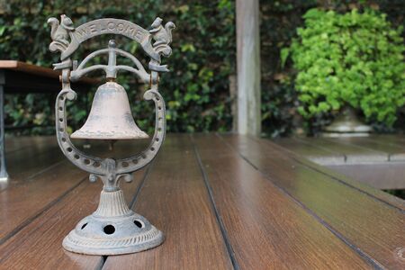 Old bell on wooden floorの写真素材