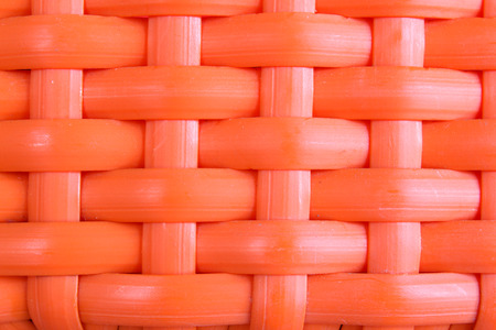 Background of orange plastic weave pattern.の写真素材