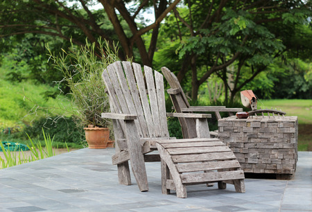 Old wooden deck chairs in the garden.の写真素材