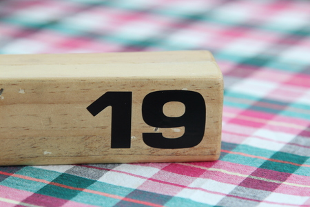 Wooden table sign with number 19 on tablecloth.の写真素材