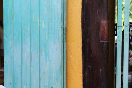 Blue wooden door and orange post.の写真素材