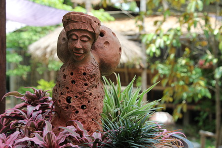 Closeup image of clay doll in flowerpot.の写真素材