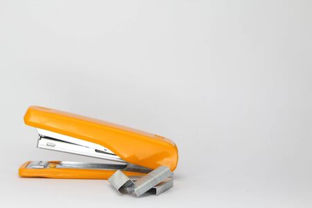 Closeup of orange stapler and staple. Focus at staple.の写真素材