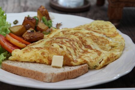Big set of breakfast on white plate.