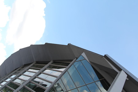 Blue sky and cloud reflected on mirror of windows of modern building.