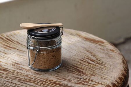 Closeup of brown sugar in sugar bowl on wooden table.の写真素材
