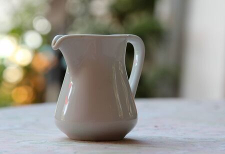 White ceramic jug on a wooden table.の写真素材