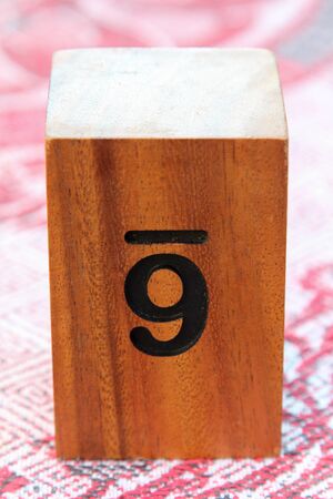 Wooden table sign with number 6 on tablecloth.の写真素材