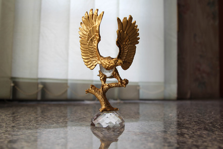 Golden eagle statue on granite slab.