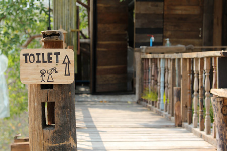 The toilet entrance bridge made from wood.の写真素材