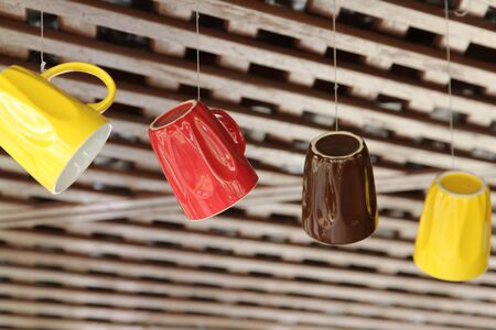Colorful coffee cups hanging on the ropes.の写真素材