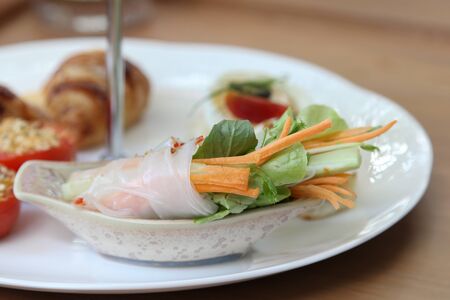 Asian traditional spring roll on white plate.
