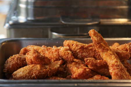 Fried fish fillet with bread crumb in stainless tray.の写真素材