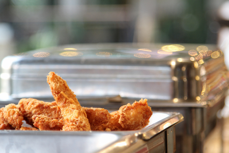 Fried fish fillet with bread crumb in stainless tray.の写真素材