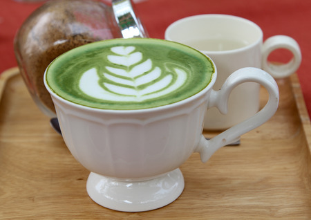 A cup of hot green tea  on table.の写真素材
