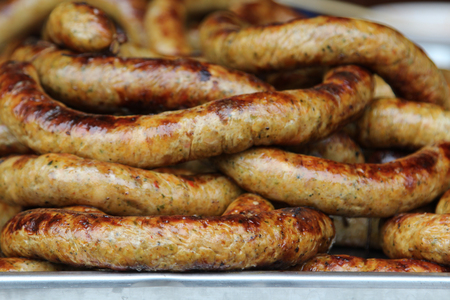 Thai food, grilled Thai sausages Northern style on stove at market.の写真素材