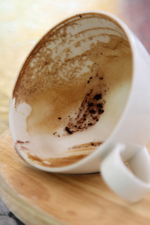 Hot cappuccino on wooden tray in morning time.の写真素材