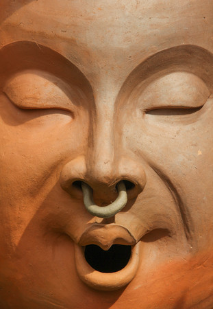 Face of smile baked clay doll, closeup.の写真素材