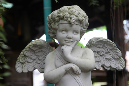 White vintage statue cupid in the garden.の写真素材