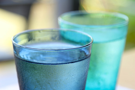 Cold water in a blue  transparent glass.の写真素材