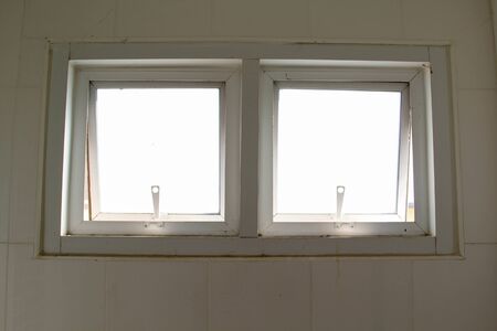 Ventilation windows on concrete wall in the bathroom.