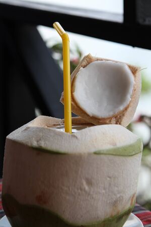 Fresh coconut fruits ready to serve as beverage on the table.の写真素材