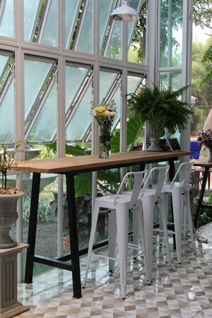 Luxury wooden table and white metal chair for lunch indoors.