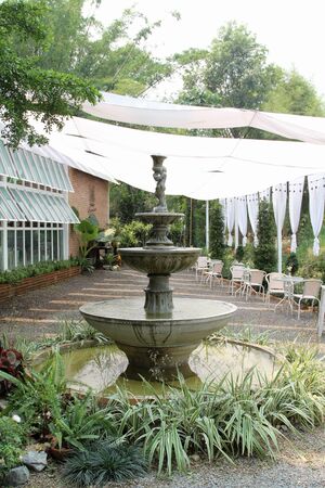 Statue of children angel water fountain in the garden.の写真素材