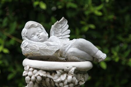 The white cupid sculpture decorated in the garden.の写真素材