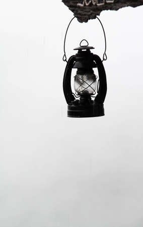 The old vintage kerosene lamp on foggy background.の写真素材