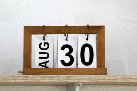 Home decoration on wooden shelf on white concrete wall.の写真素材