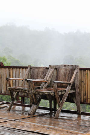 The old wooden chairs on terrace with mountain views background.の写真素材