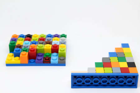 Colorful plastic building blocks isolated on white background.
