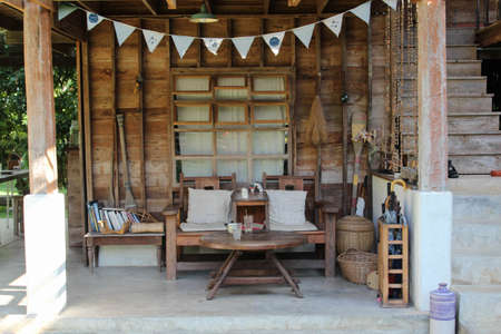 Open space living area with old wooden table and chairs.の写真素材