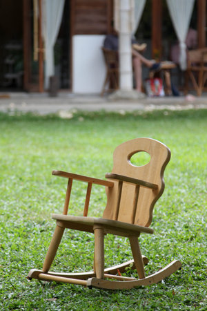 Wooden rocking chair on green grass.の写真素材