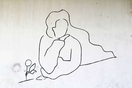 A woman line art on white concrete wall.