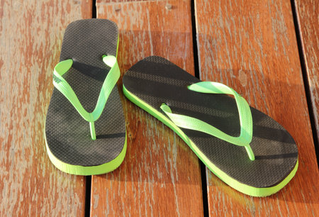 The sandals shoes on the wooden floor.の写真素材