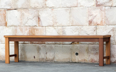 Chair and stone wall beside the swimming pool.