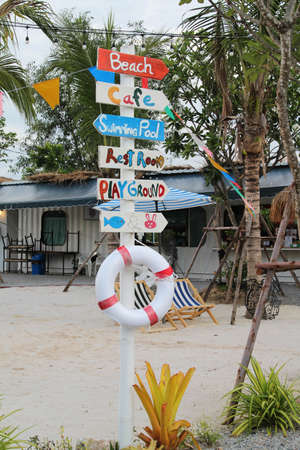 Wooden directional signs on the beach.