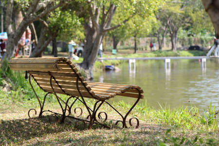 The old relaxing bench by the lake.の写真素材