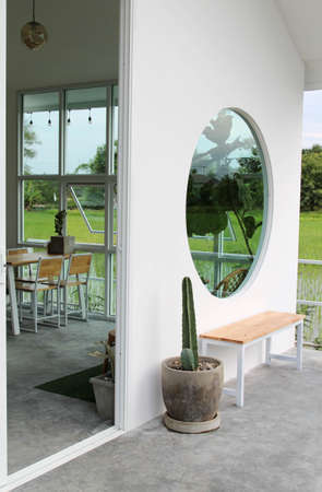 The wooden bench  beside white concrete wall.の写真素材