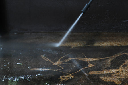 Cleaning concrete floor by high pressure water jet.の写真素材