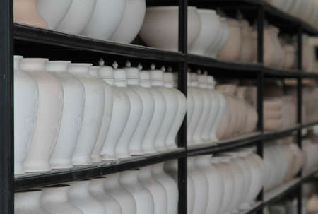 The clay pottery ceramic products dry on shelf in pottery factory.