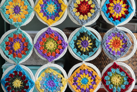 Crocheted flowers hanging on wall texture backgroundの写真素材