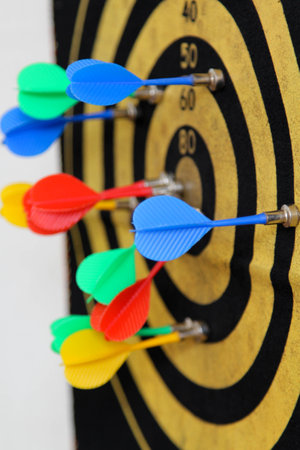 Dart board with darts on white wallの写真素材