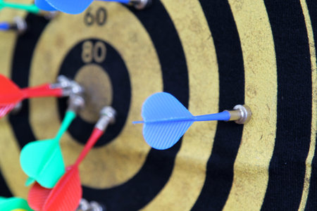 Dart board with darts on white wallの写真素材