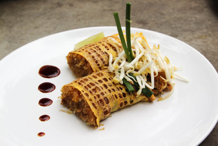 Pad Thai - Thai fusion food - Stir fried rice noodles on white ceramic plateの写真素材