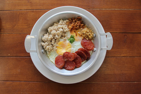 Vietnam food, Pan fried egg serve with sausage and pork on wooden tableの写真素材