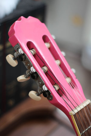 An pink acoustic guitar head with tuning pegsの写真素材